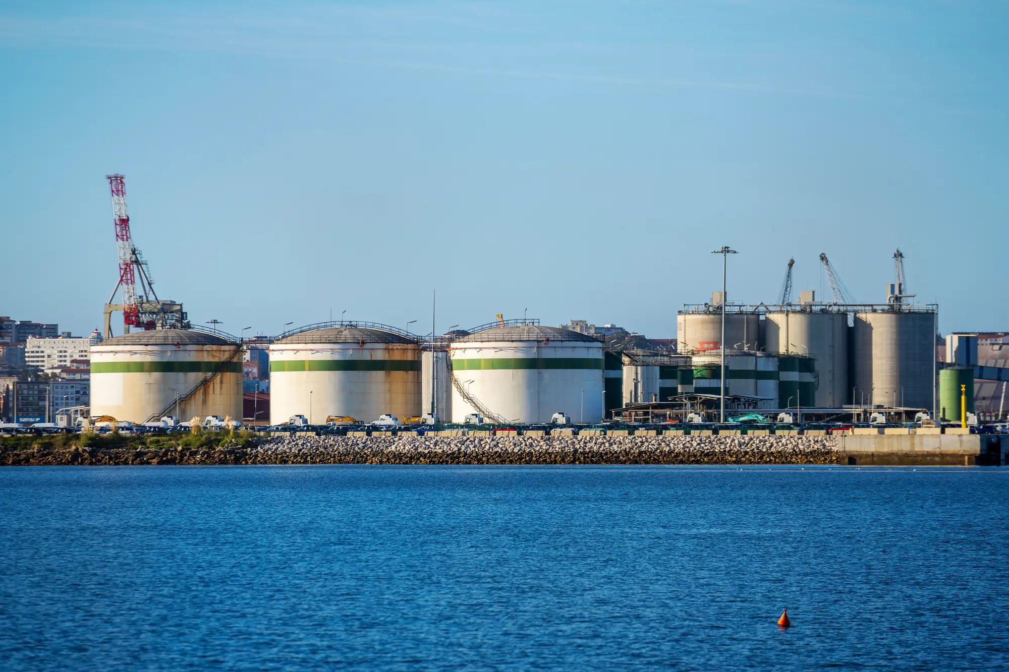 Storage tanks at a port terminal, seen across the water